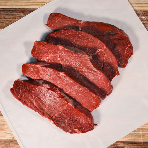 Five pounds Top Sirloin Steaks on butcher paper