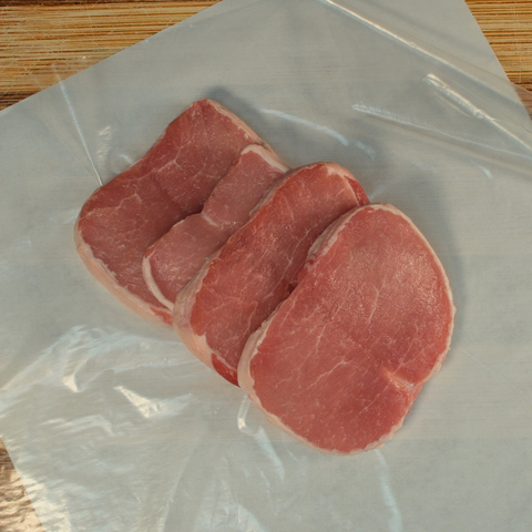 Four butterfly pork chops on butcher paper