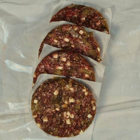 Four Mushroom and Swiss Burger Patties on butcher paper
