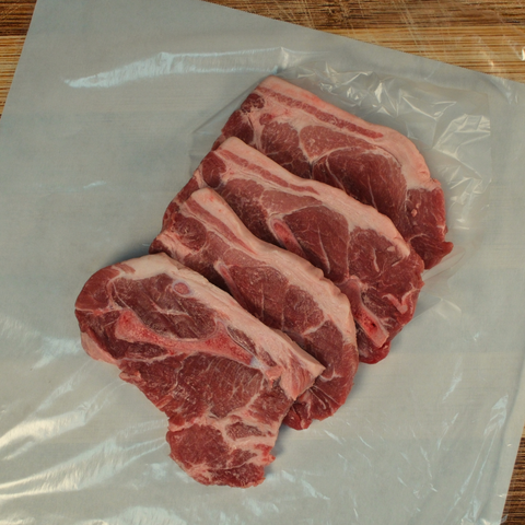 Four Pork Steaks on butcher paper