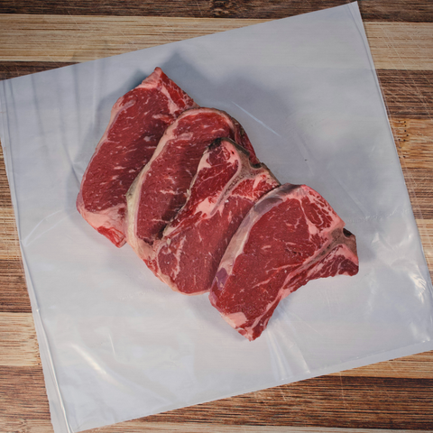 Four T-Bone Steaks on butcher paper