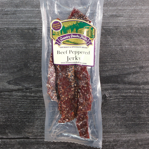 Packaged beef peppered jerky with a label on a wooden surface