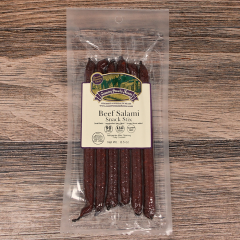 Packaged Beef Salami Snack Stix on a wooden surface