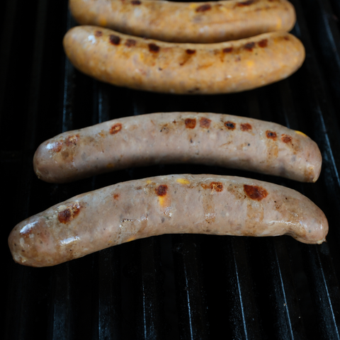 Grilled Cheeseburger Brats on a barbecue grill