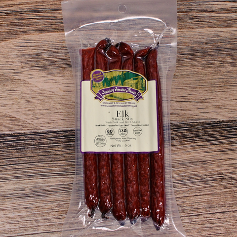Packaged elk snack sticks with a label on a wooden surface