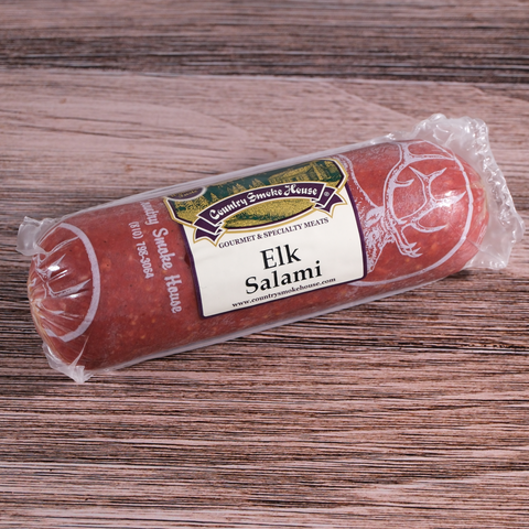 Packaged Elk Salami Chub on a wooden surface