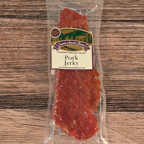 Packaged pork jerky with a label on a wooden surface