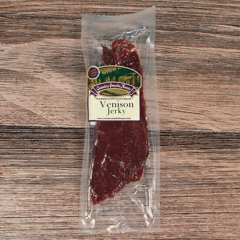Packaged venison jerky on a wooden surface