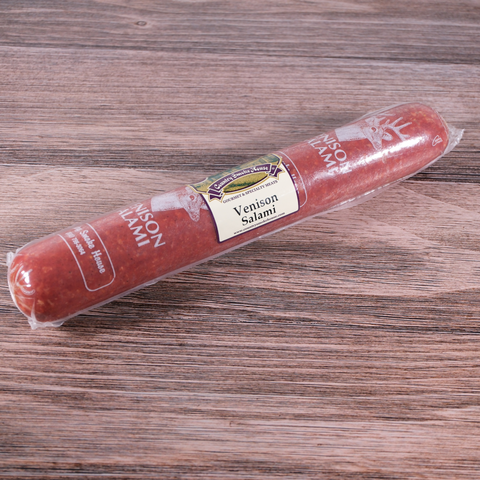 A packaged of Venison Long Salami on a wooden surface.