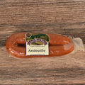 Packaged Andouille sausage on a wooden surface