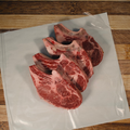 Four Bone In Ribeye Steaks on butcher paper