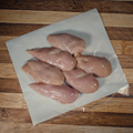 Five pounds of trimmed chicken breasts on butcher paper