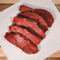 Five pounds Top Sirloin Steaks on butcher paper