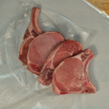 Four bone in center cut pork chops on butcher paper