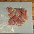 Three pounds of Boneless Chicken Thighs on butcher paper