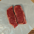 New York Strip Steaks on butcher paper