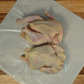 Two whole chickens on butcher paper