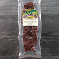Packaged beef BBQ jerky with a label on a wooden surface