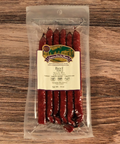 Packaged beef BBQ Snack sticks with a label on a wooden surface
