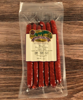 Packaged beef bacon cheddar snack sticks with a label on a wooden surface