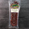 Packaged beef cajun jerky with a label on a wooden surface