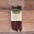 Packaged Beef Carolina Reaper Snack Stix on a wooden surface with a label.