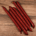 Beef Cheddar Cheese Snack Stix on a wooden surface