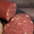 A sliced Beef Jalapeno Cheese Salami Chub on a wooden background