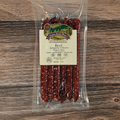 Packaged Beef Jalapeno Cheese Snack Stix on a wooden surface