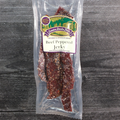 Packaged beef peppered jerky with a label on a wooden surface