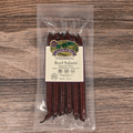 Packaged Beef Salami Snack Stix on a wooden surface
