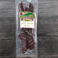 Packaged beef teriyaki jerky on a wooden surface