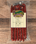 Packaged beef teriyaki snack sticks with a label on a wooden surface
