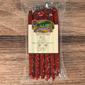 Packaged Beef Teriyaki Snack Stix with a label on a wooden surface