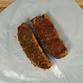 Black Garlic New York Strip Steaks on butcher paper