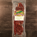 Packaged Buffalo BBQ Jerky with a label on a wooden surface