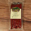 Packaged Buffalo Jalapeno Cheese Snack Stix with a label on a wooden surface