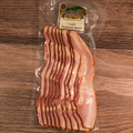 Packaged Premium Sugar Cured Cajun Bacon on a wooden surface