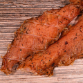 Close-up of  Caribbean Jerk Turkey Jerky  on a wooden surface