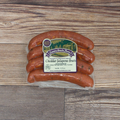 Packaged Cheddar Jalapeno Brats on a wooden surface.