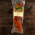 Packaged Chicken Teriyaki Jerky with a label on a wooden background
