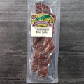 Packaged Dill Pickle Beef Jerky with a visible brand label on a wooden surface