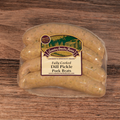 Packaged Dill Pickle Brats on a wooden surface.