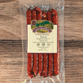 Packaged duck jalapeño cheese snack sticks with a label on a wooden surface