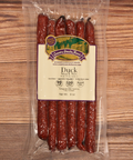 Packaged duck snack sticks with a label on a wooden surface