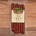 Packaged duck snack sticks with a label on a wooden surface