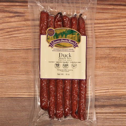 Packaged duck snack sticks with a label on a wooden surface