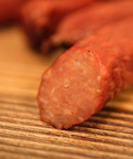 Close-up of a duck snack stick on a wooden surface