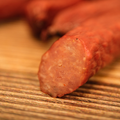 Close-up of a duck snack stick on a wooden surface