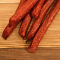 duck snack sticks on a wood surface